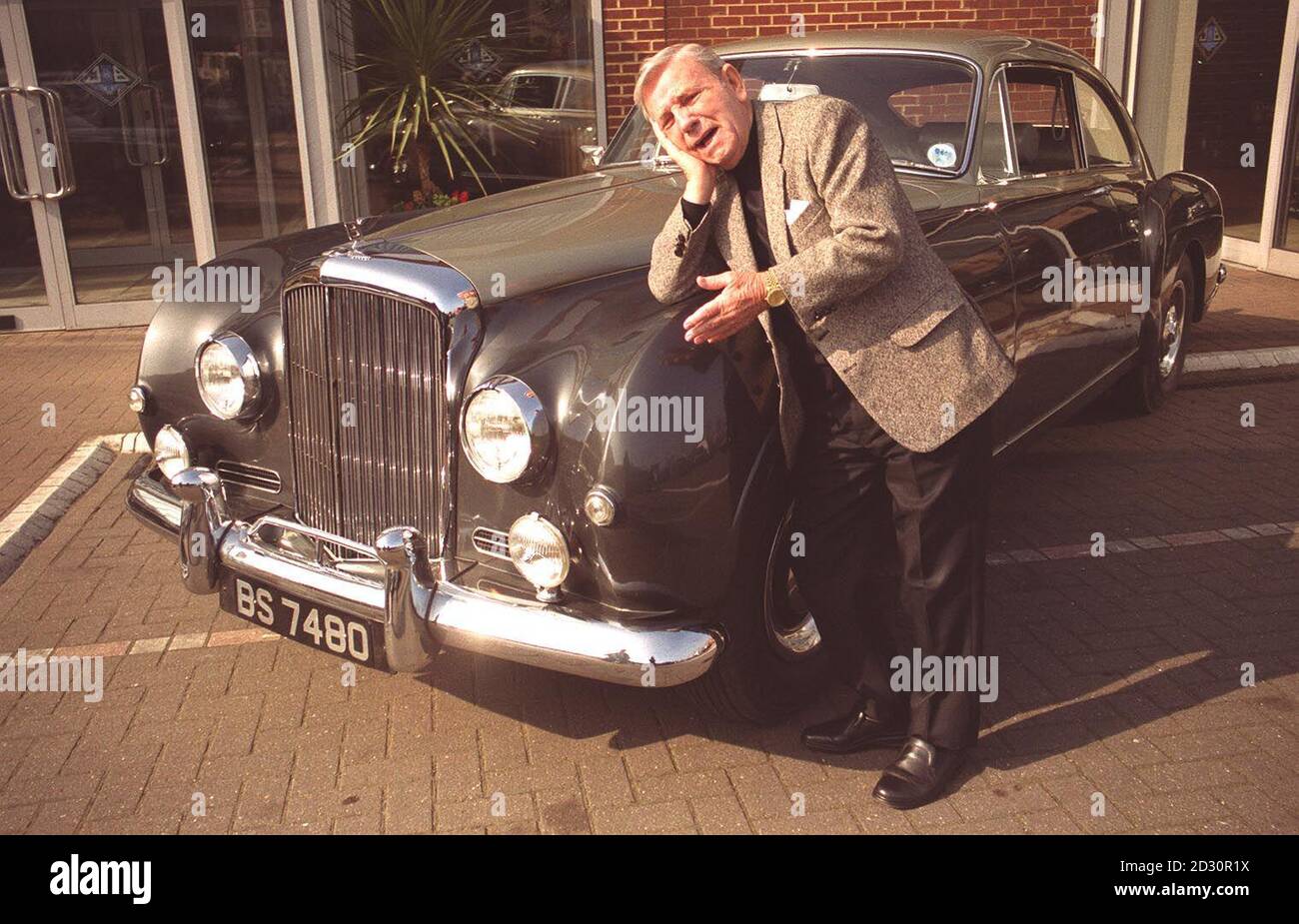 Le comédien Norman Wisdom à Londres, en train de dire un Au revoir téreux à son Fastback continental Bentley S1 de 1956, dont la valeur est estimée entre 40,000 et 50,000.Le véhicule est offert à la vente chez Christies exceptionnel Motor cars et à la vente d'Automobilia. Banque D'Images