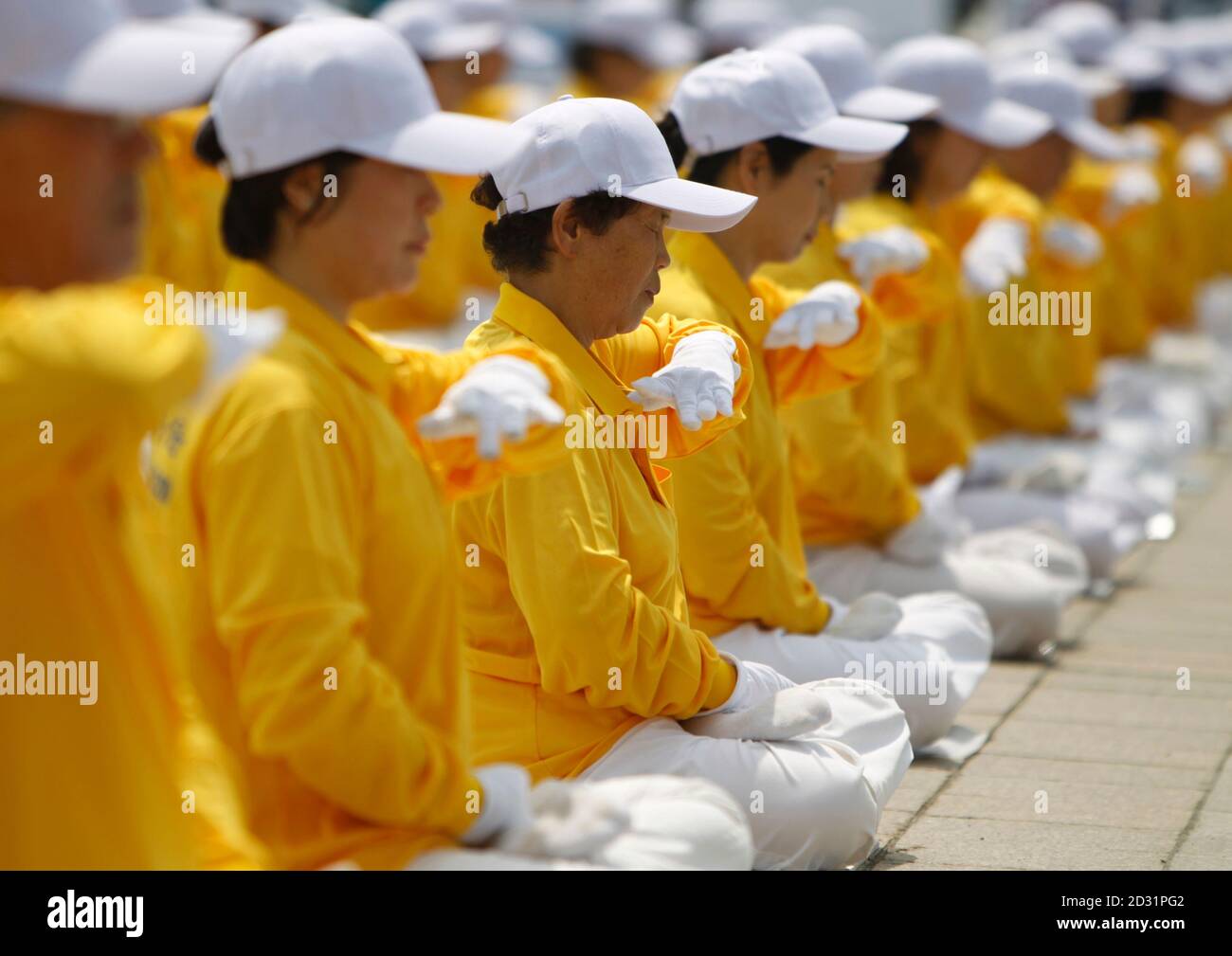 South Korean Falun Gong practitioners meditate as they commemorate the 11th  anniversary of International Falun Gong Day, which falls on May 13, in  Seoul May 9, 2010, while they also stage a