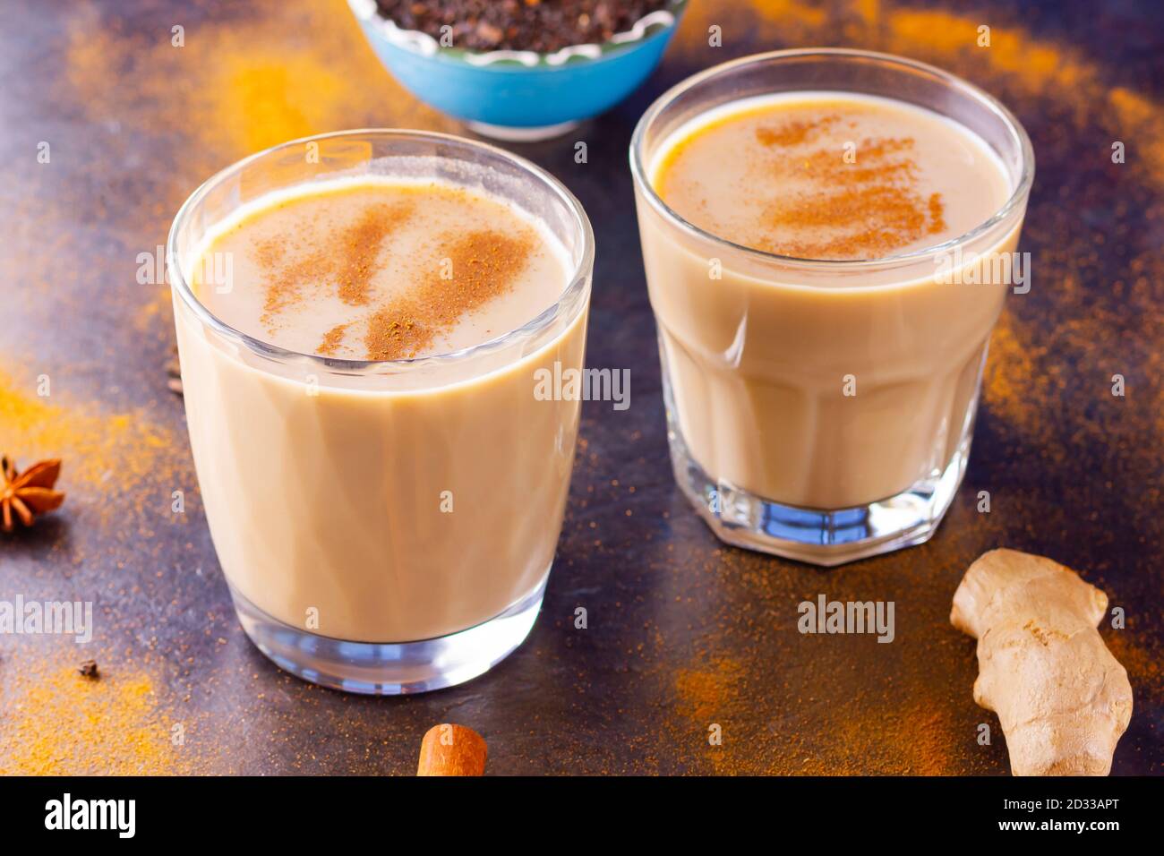Thé Chai de masala sur fond noir. Deux verres transparents de thé masala et diverses épices éparpillées. Vue de dessus Banque D'Images