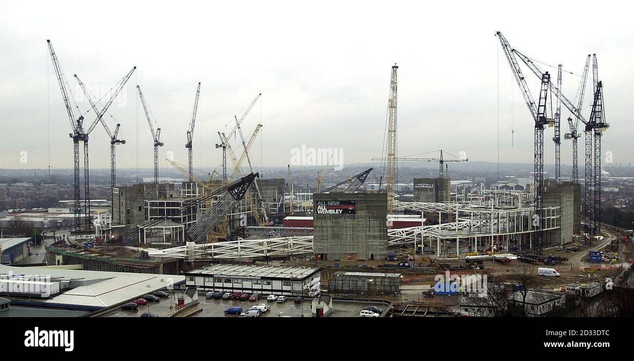 Une forêt de grues montre la forme à venir du nouveau stade Wembley de 90,000 places, actuellement en construction dans le nord de Londres, qui doit ouvrir début 2006. La caractéristique hautement visible la plus frappante du nouveau stade sera une arche de 133 mètres de haut qui se trouve au-dessus de la position nord. La voûte en acier fait 315 mètres de long et deviendra la plus longue structure de toit au monde. Les rangées de sièges, si elles sont placées de bout en bout, s'étendraient sur 54 kilomètres et le stade aura 2,000 toilettes. *11/03/04: La voûte de 440ft a été déclarée dangereuse pour se lever en position, il est apparu. Contrôle de sécurité Banque D'Images