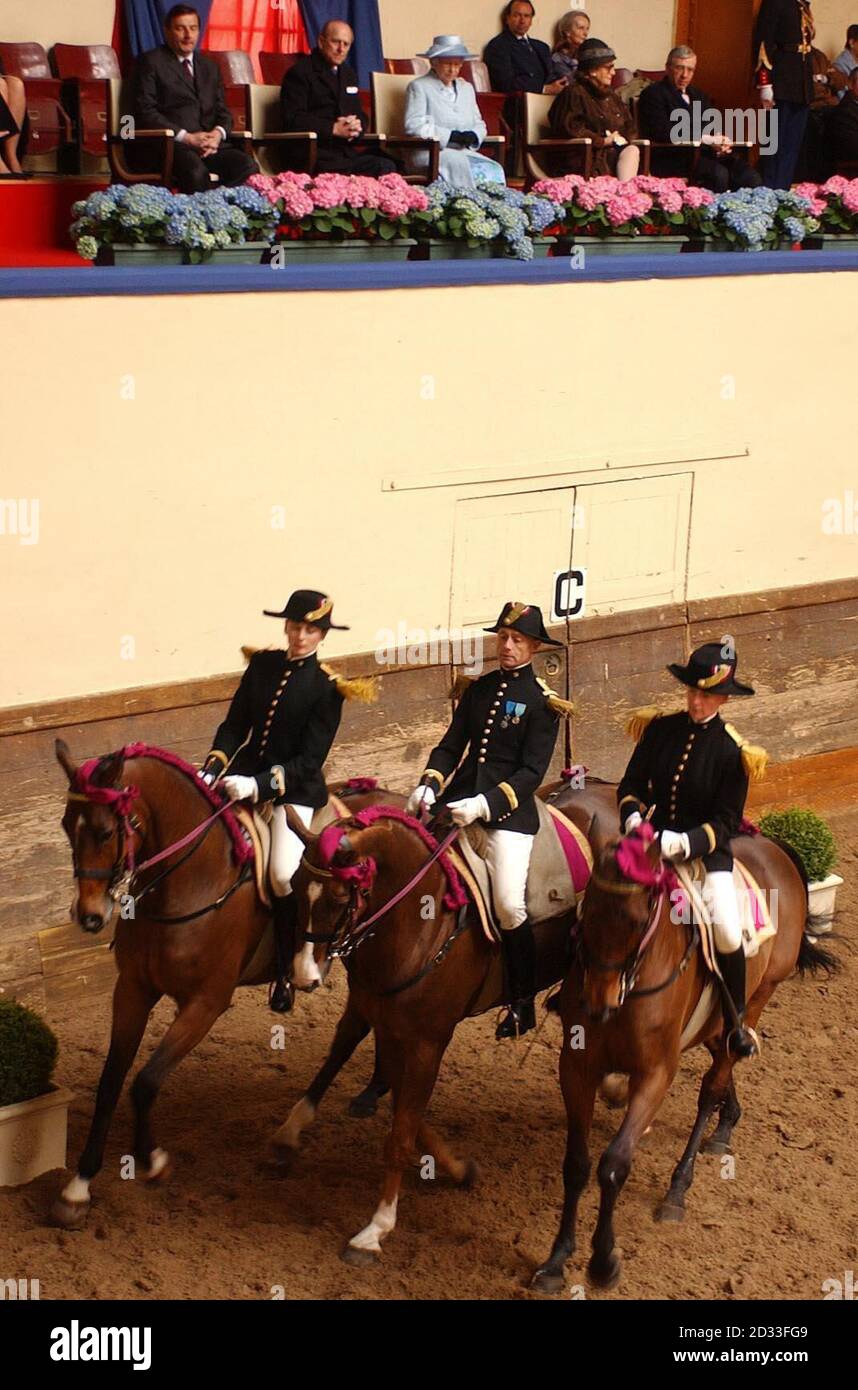 La reine Elizabeth II (C) de Grande-Bretagne assise avec le duc d'Édimbourg (L), l'épouse du président français Jacques Chirac Bernadette (première droite), le secrétaire aux Affaires étrangères Jack Straw (deuxième droite) lors de sa visite officielle à Paris, observe une équipe de dressage d'élite à Paris. Plus tôt aujourd'hui, des centaines de personnes ont bordé les trottoirs pavés de la rue pour voir la Reine, les adeptes de la finition se sont retrouvés sur leurs balcons en agitant pendant qu'elle a marché entre les restaurants et les magasins. Banque D'Images