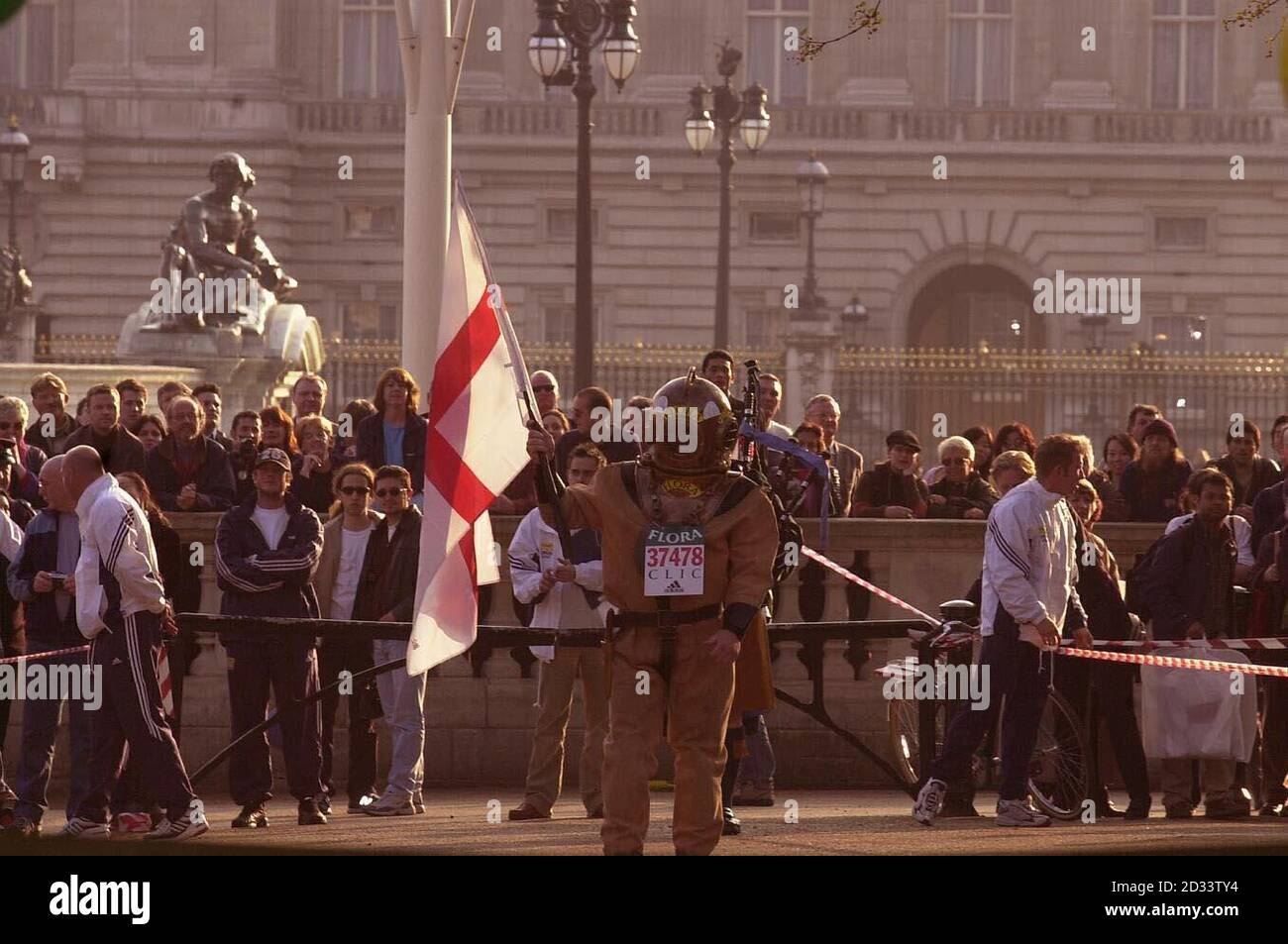 Lloyd Scott ayant terminé les derniers mètres du marathon de Londres, Lloyd, le coureur de marathan le plus lent de l'histoire, a « couru » le parcours en portant un costume de plongée antique en six jours. Lloyd espère avoir grandi dans la région de 100,000 en faveur du cancer et de la leucémie dans l'enfance grâce à ses efforts. Banque D'Images