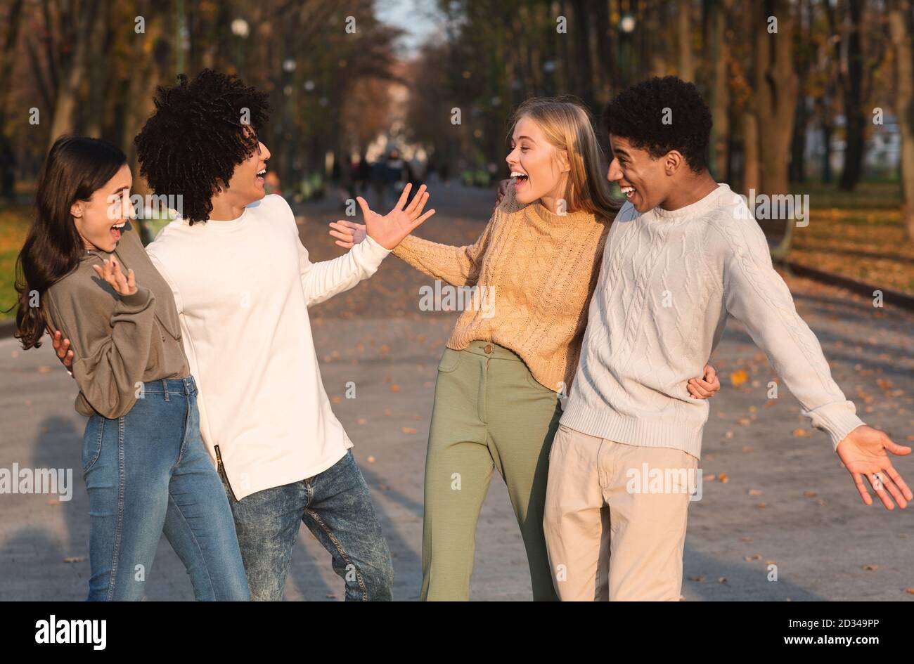 Deux couples de jeunes adolescents de race mixte se sont réunis dans le parc public Banque D'Images