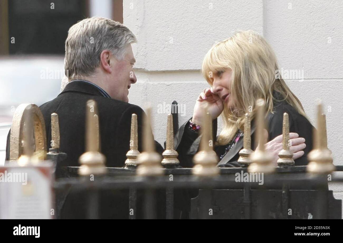 Pat Kenny (à gauche) console une femme non identifiée à l'extérieur de la maison familiale de Gerry Ryan, dans la banlieue nord de Dublin, à Clontarf, où un réveil pour l'ancien diffuseur irlandais a lieu ce soir. Banque D'Images