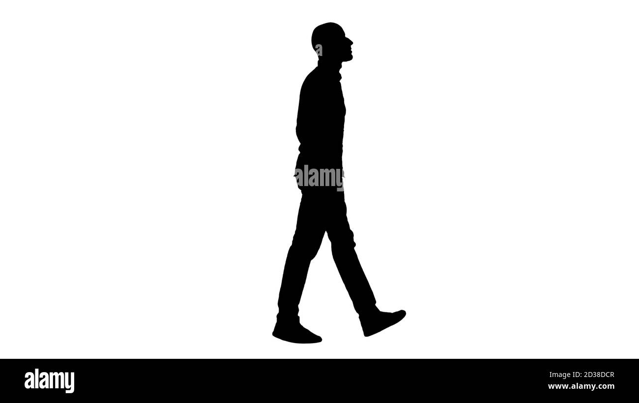 Silhouette assurée dans son modèle de style walkin avec les mains dans les poches. Banque D'Images