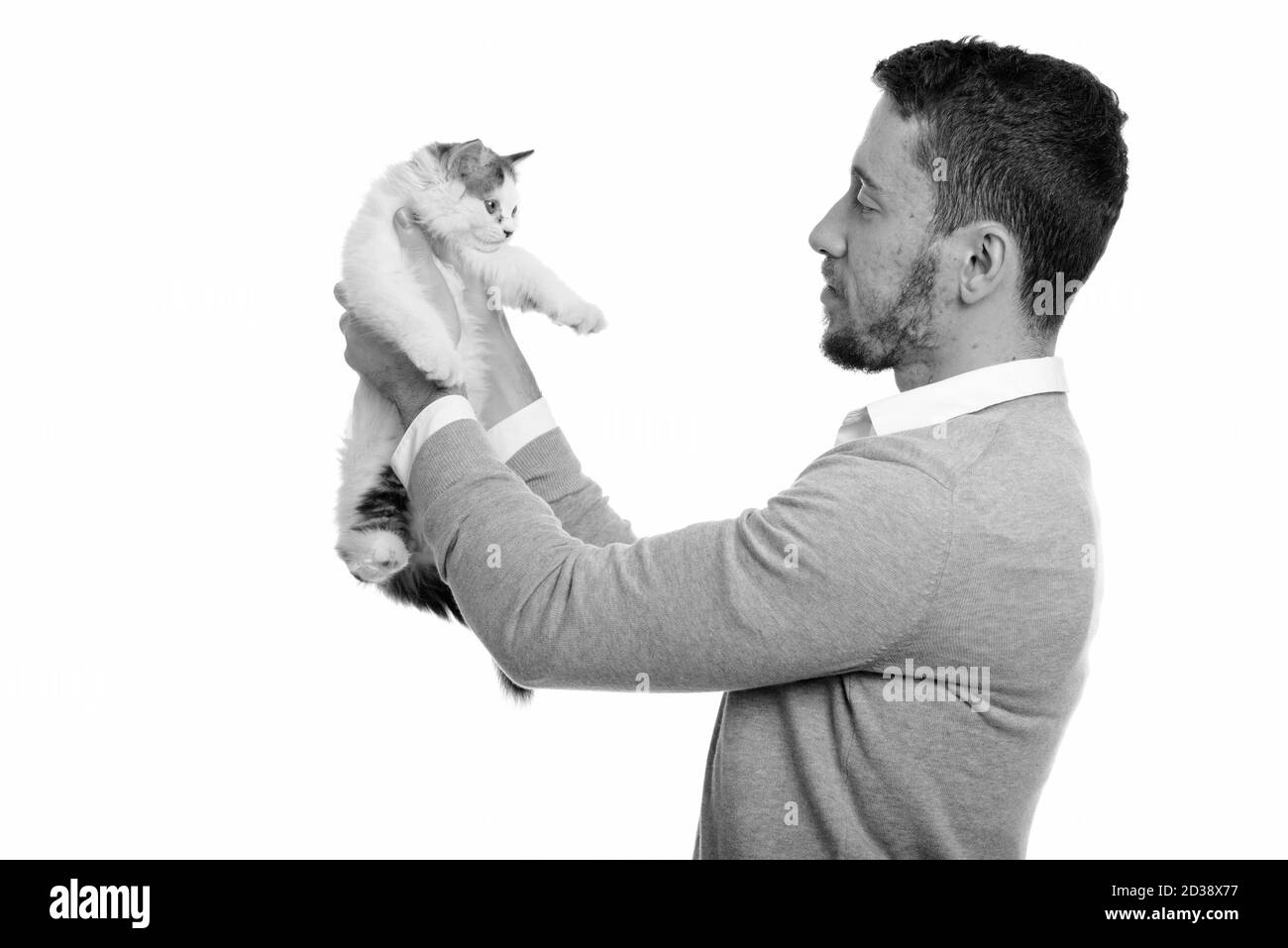 Voir le profil de jeunes handsome Young man holding cat Banque D'Images