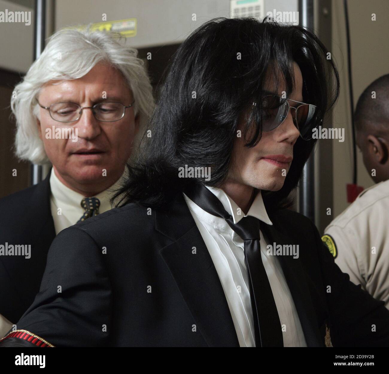Michael Jackson goes through security as he arrives at Santa Barbara County  Superior Court in Santa Maria, California with his attorney Thomas Mesereau  Jr, (L), June 13, 2005. The jury in the