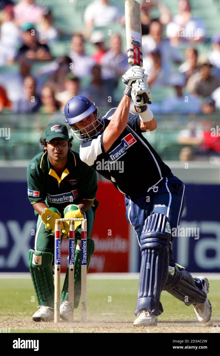 World XI team player Chris Cairns hits a six as Asian XI wicketkeeper Kumar  Sangakkara from Sri Lanka looks on during their game in Melbourne. World XI  team player Chris Cairns (R)