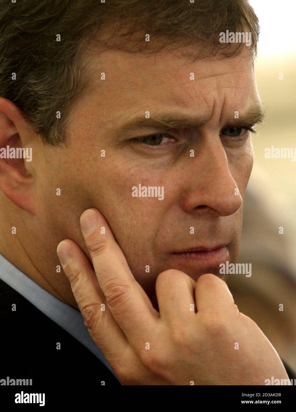 Britain's Prince Andrew the Duke of York, (L) looks on [as British cook  Rick Stein prepares Scottish mussels] in the gardens of the British Embassy  residence in Paris, June 25. 2002. [The