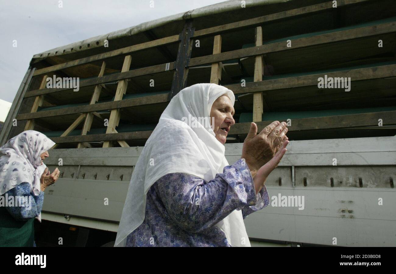 Bosnian Muslim women pray in Visoko in front of a truck carrying Srebrenica  victims for burial. Bosnian Muslim women pray July 9, 2005 in the Bosnian  town of Visoko in front of