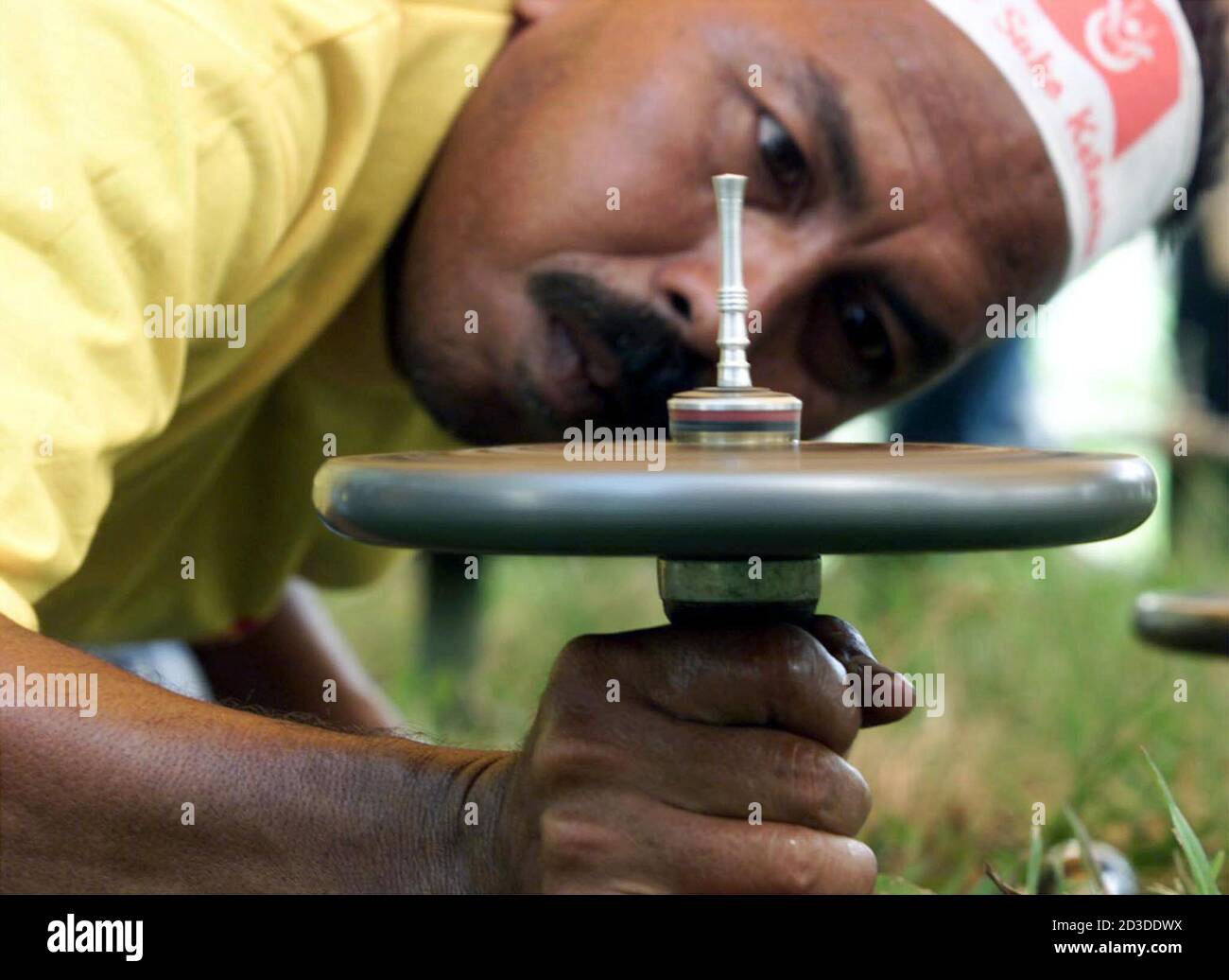 A Malaysian Top Spinner Balances His Giant Top During A Competition In Kota Bharu 600 Kilometres North East Of Kuala Lumpur September 3 2000 Top Spinning Is A Favourite Pastime In The Peninsular Malaysia S