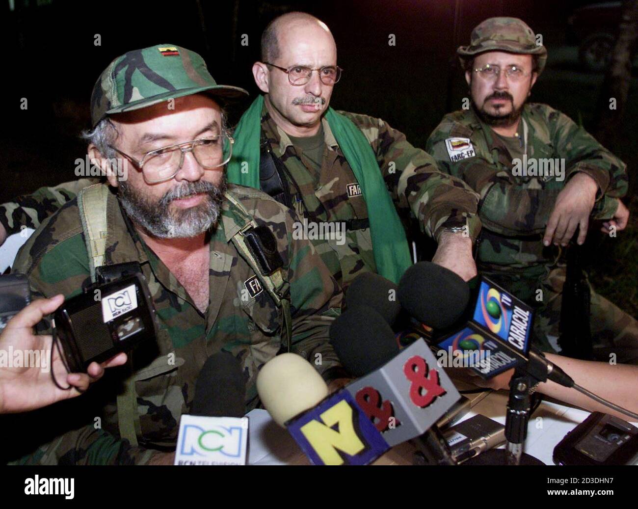 Rebel commander Raul Reyes (L) of the Revolutionary Armed Forces of  Colombia (FARC), gives a news conference while commanders Simon Trinidad  (C) and Carlos Lozada listen on in the rebel camp of