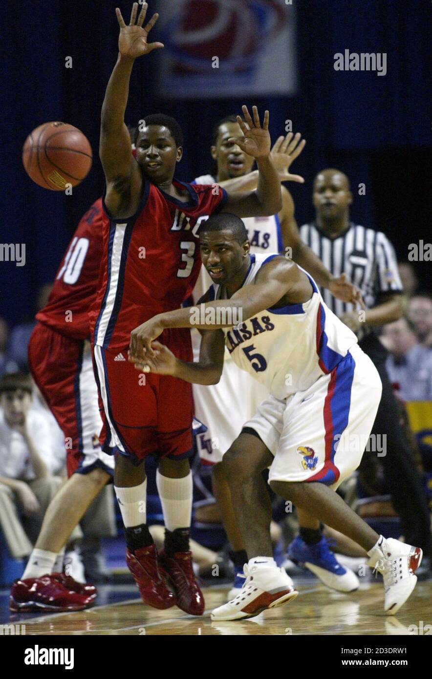 University of Kansas guard Keith Langford (5) passes off while being  pressured by University of Illinois-Chicago guard Martell Bailey (3), in  the half of their first round men's NCAA basketball game in