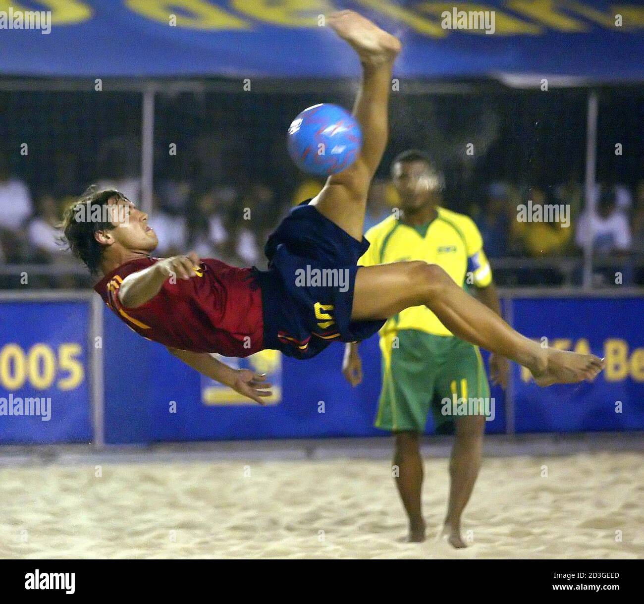 Spain's Amarelle performs a scissors-kick as veteran Brazilian striker  Faria looks on during their FIFA Beach Soccer World Cup match in Rio de  Janeiro. Spain's Ramiro Amarelle (L) performs a scissors-kick as