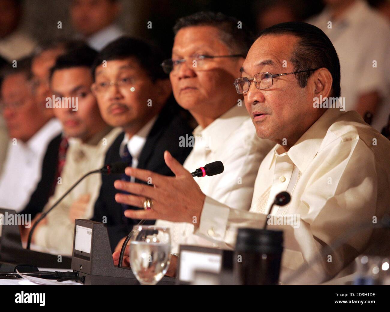 Executive Secretary Ermita Gestures While Seated With Other Cabinet Members Loyal To President Arroyo During A News Conference In Manila Philippine President Gloria Macapagal Arroyo S Executive Secretary Eduardo Ermita R Gestures While