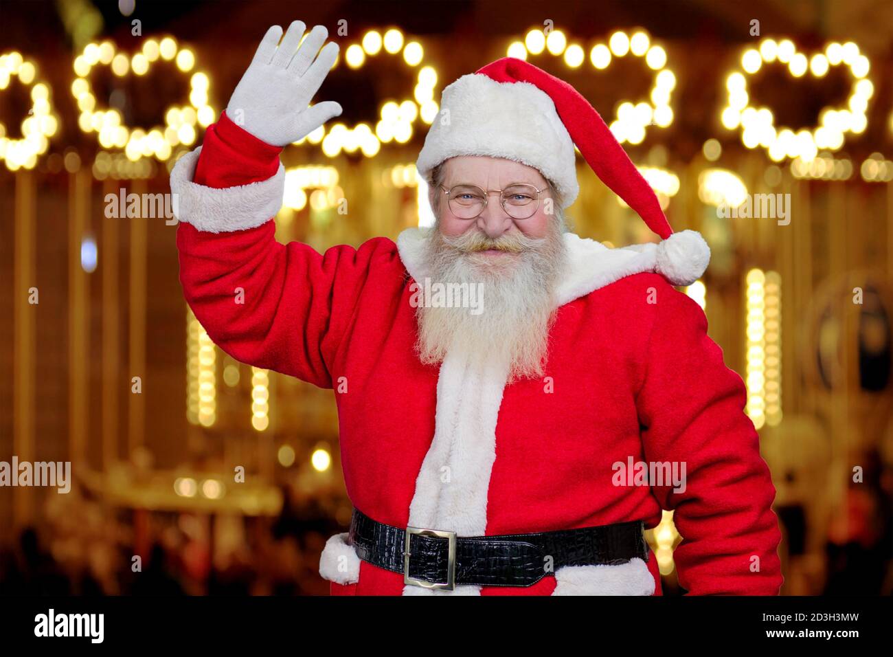 Le Père Noël souriant et agitant. Banque D'Images