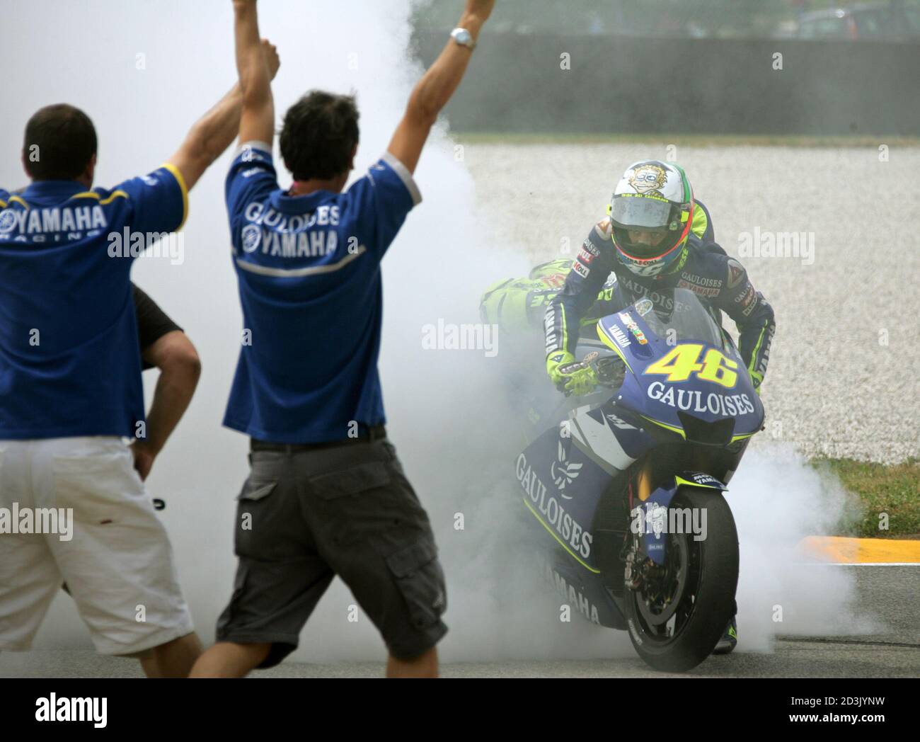 MotoGP rider Rossi of Italy burns his tire in celebration after winning  Italian Motorcycle Grand Prix in Mugello. MotoGP rider Valentino Rossi of  Italy burns his tire in celebration after winning the