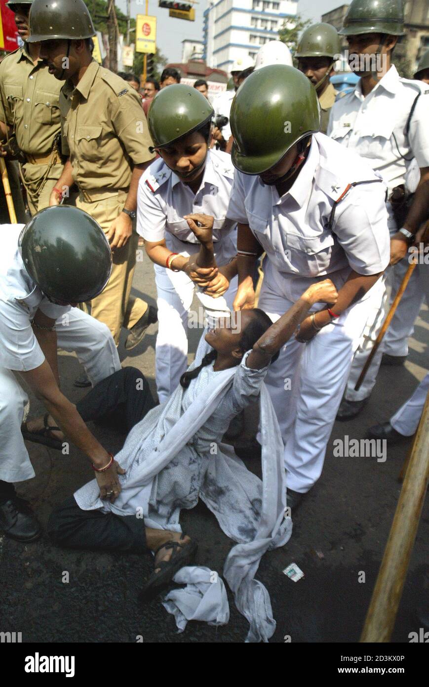 Indian police scuffle with a woman activist of the Socialist Unity Centre  of India party during a protest in Calcutta. Indian police scuffle with a  woman activist of the Socialist Unity Centre