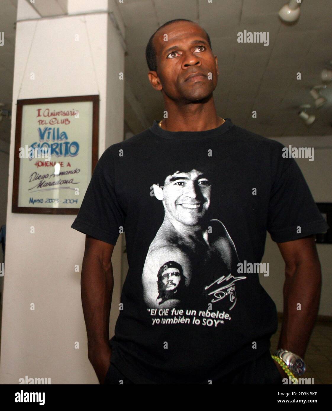 Cuban fan Rene Linares shows off a shirt given to him by Diego Armando  Maradona showing the Argentine soccer idol and his Ernesto "Che" Guevara  tattoo and the headline reading "Che was