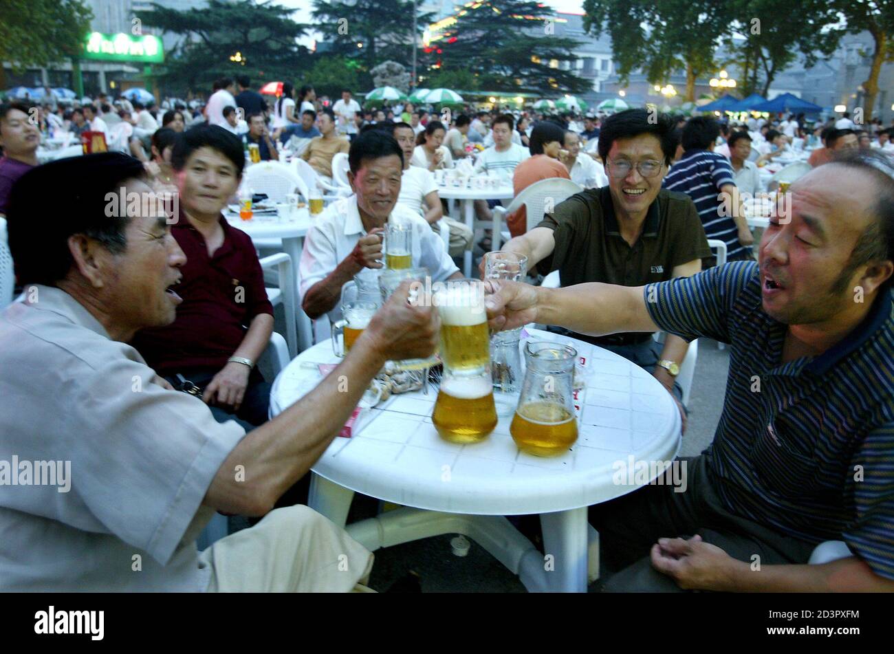 Chinese drinkers toast at a beer festival in Jinan, capital of China's  eastern Shandong province, August 1, 2004. China is the largest and fastest  growing beer market in the world, and is