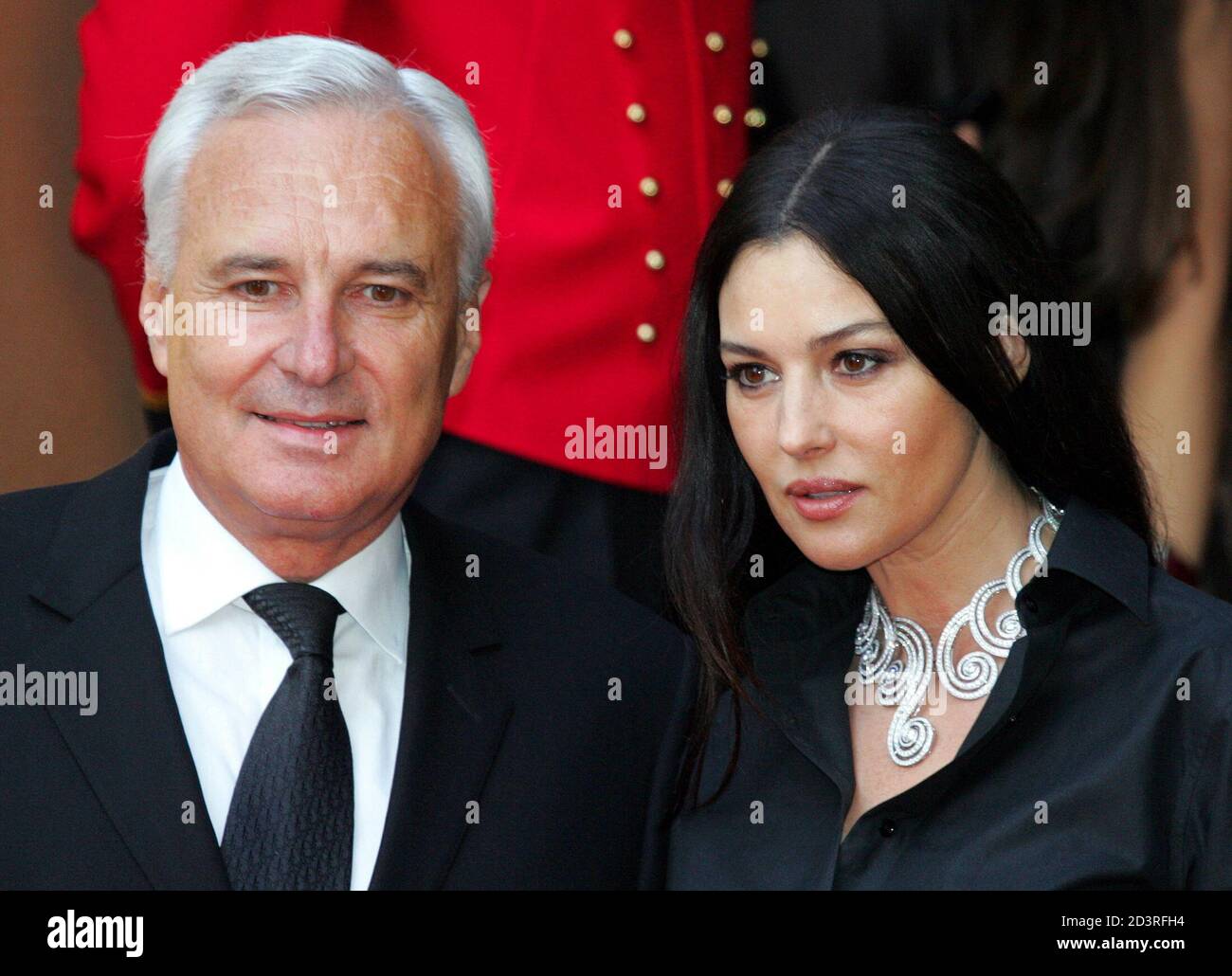Bernard Fornas (L), president and CEO of Cartier International, poses with  Italian actress Monica Bellucci as they arrive for a presentation of the  new Cartier collection in Moscow June 2, 2005. They