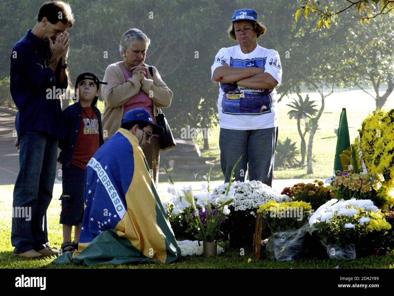Fans Of Brazilian Formula One Driver Ayrton Senna Pray At His Grave Site In The Morumbi Cemetery In Sao Paulo May 1 04 Senna Died Ten Years Ago Following His Fatal Car