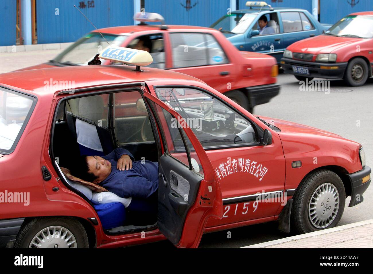 A Chinese Taxi Driver Takes A Siesta After Lunch On A Street In Beijing October 04 Working At Least 13 Hours A Day Seven Days A Week Many Of Beijing S 130 000