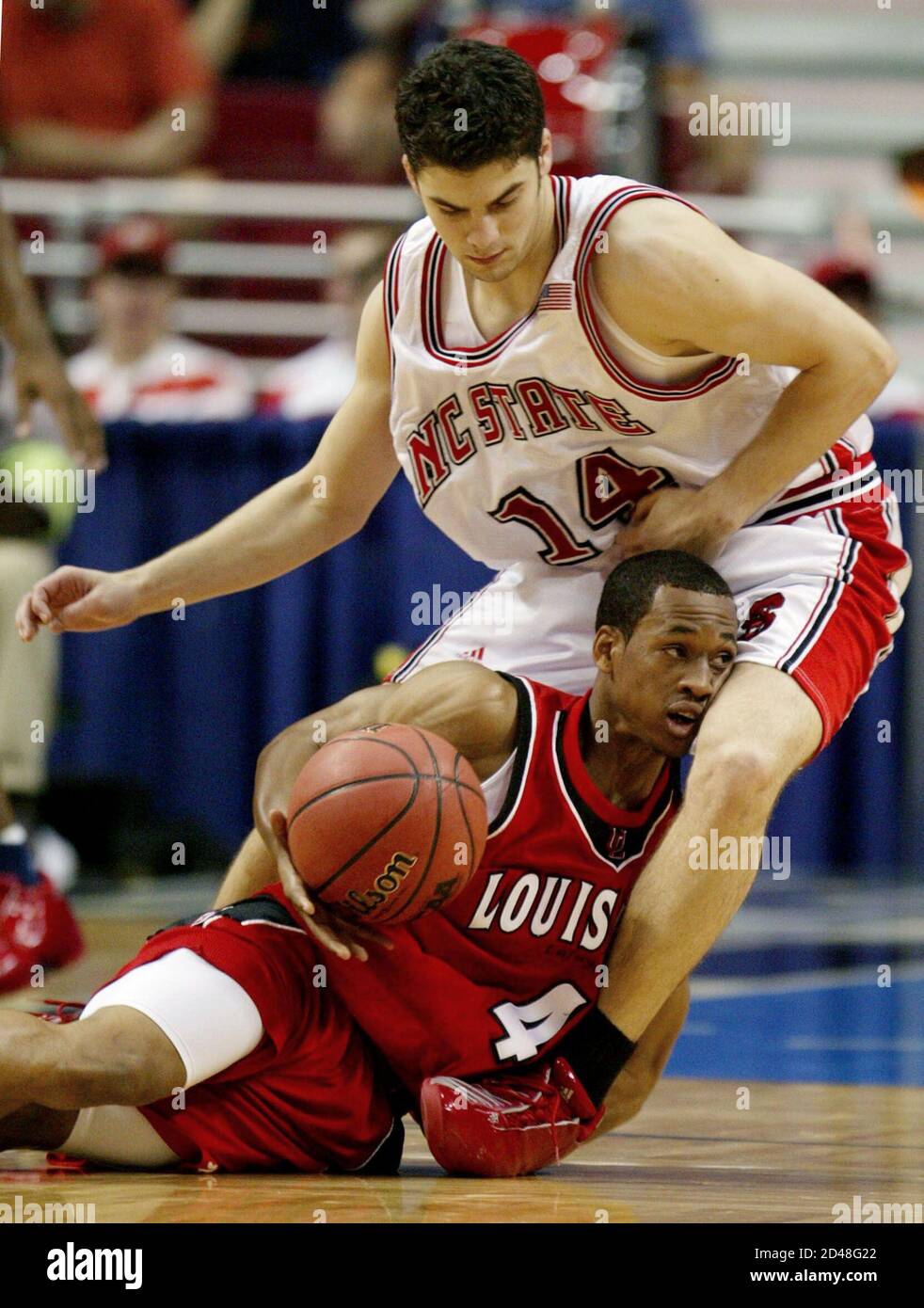 University of Louisiana-Lafayette guard Antoine Landry (L) looks for a  teammate for help, under pressure from North Carolina State University  defender Engin Atsur, of Turkey, during their first round NCAA basketball  game