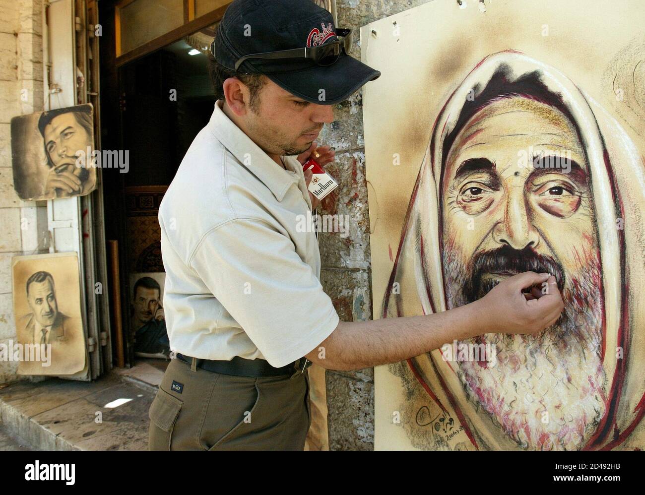 Palestinian artist Walid Ayoub sketches a portrait of the assassinated  spiritual leader of Hamas Sheikh Ahmed Yassin, in the West Bank city of  Ramallah April 12, 2004. The Middle East, overshadowed by