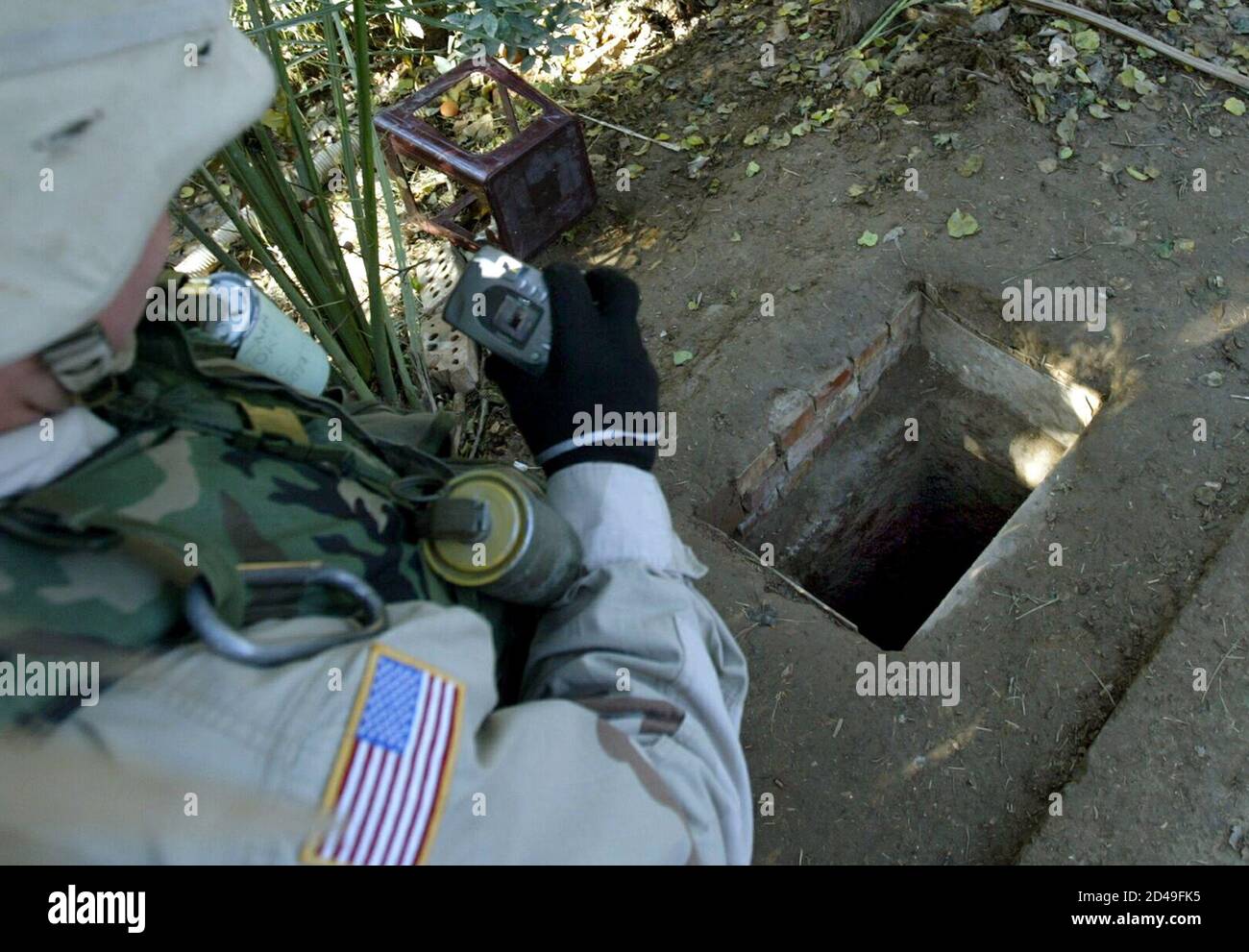 A Soldier With The Fourth Infantry Division Takes A Picture December 21 03 Of The Spider Hole Where Saddam Hussein Was Found Hiding When He Was Captured By U S Troops Near Tikrit