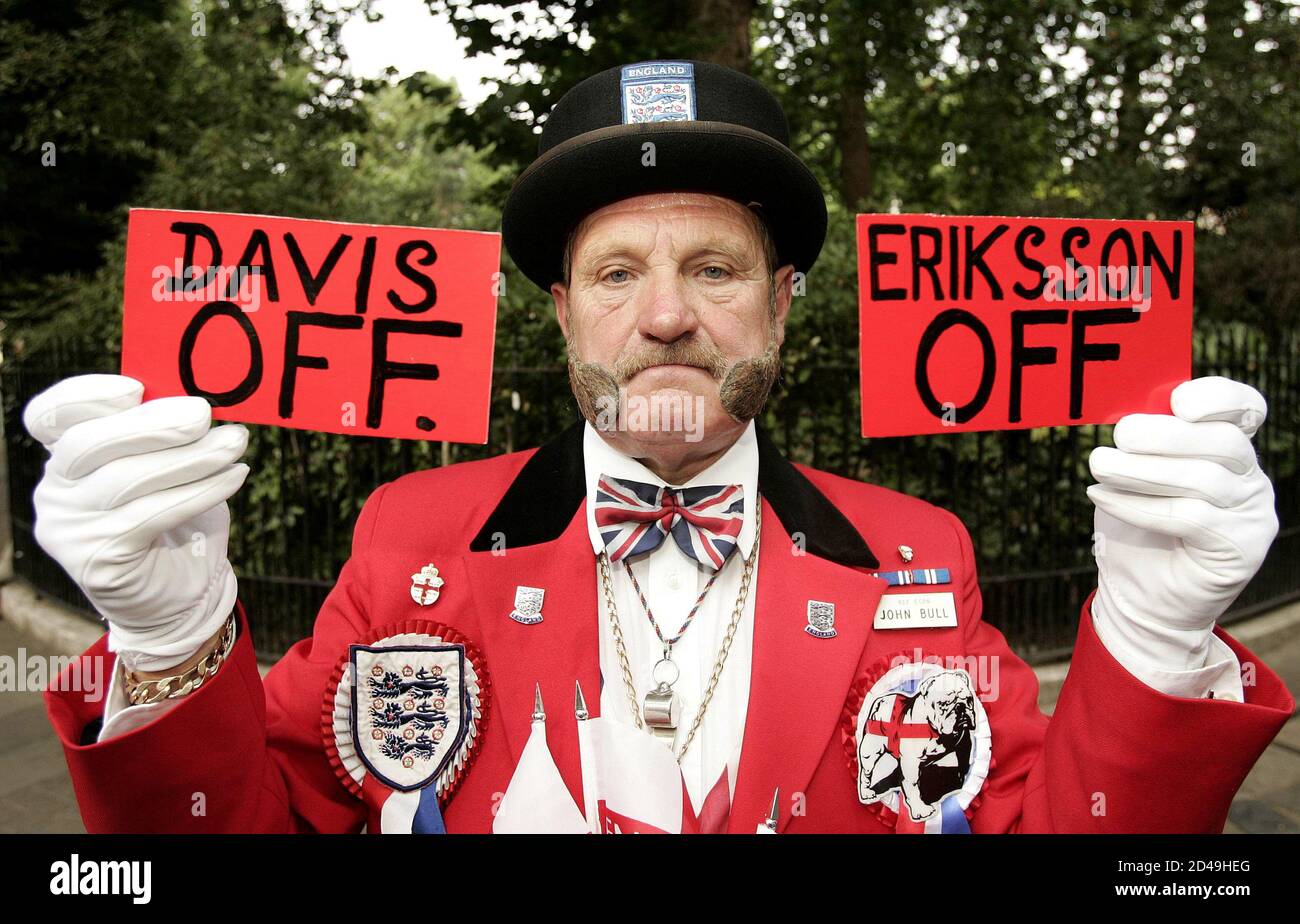 Protestor Ray Egan, dressed as fictional English character John Bull, holds  up red cards for English Football Association Executive Director David  Davies and head coach Sven-Goran Eriksson outside FA headquarters in London,