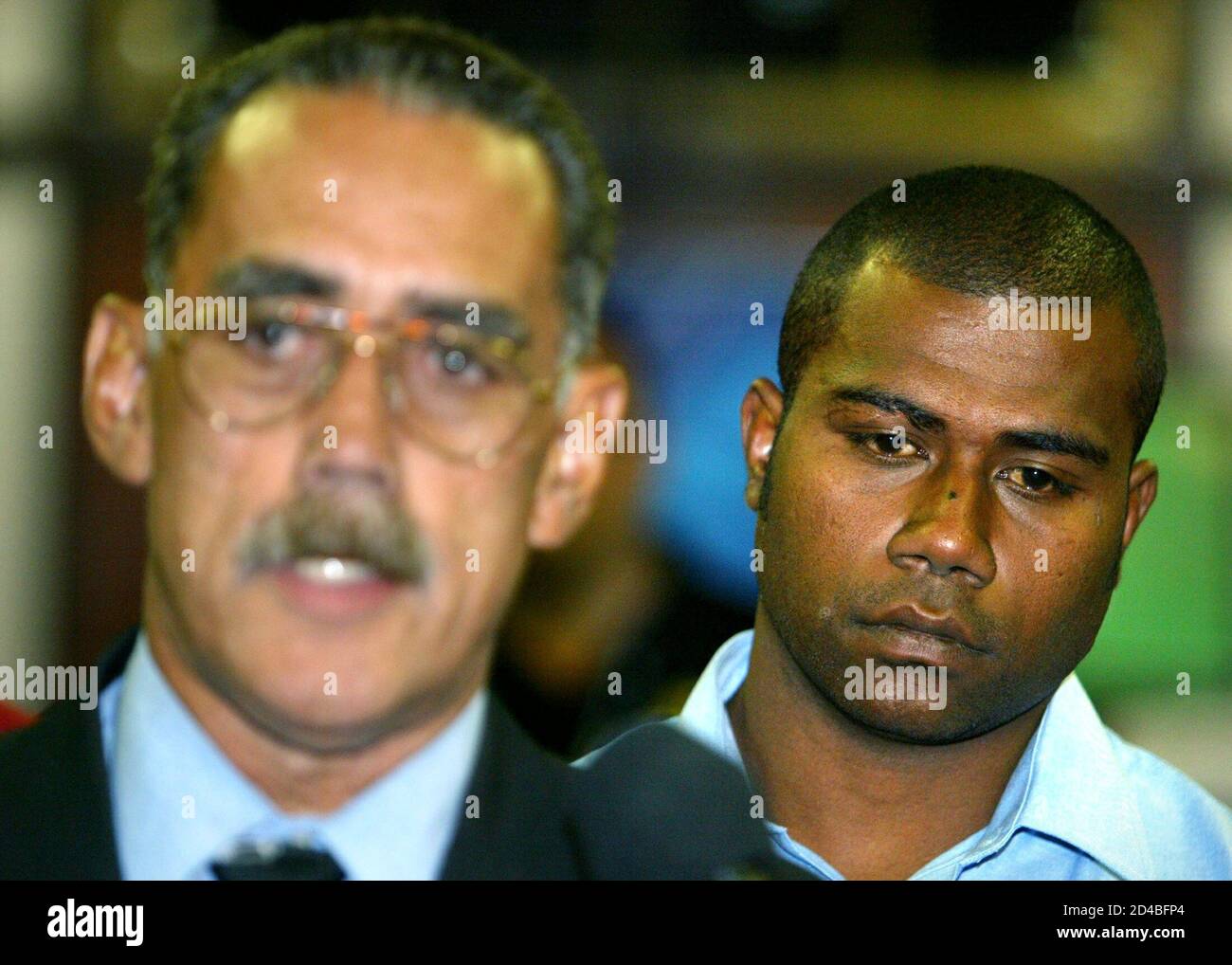 Fiji's rugby winger Rupeni Caucaunibuca (R) reacts as team manager Joe Brown  (L) makes a statement after Caucaunibuca faced the Rugby World Cup  judiciary October 13, 2003. Caucaunibuca was suspended for two