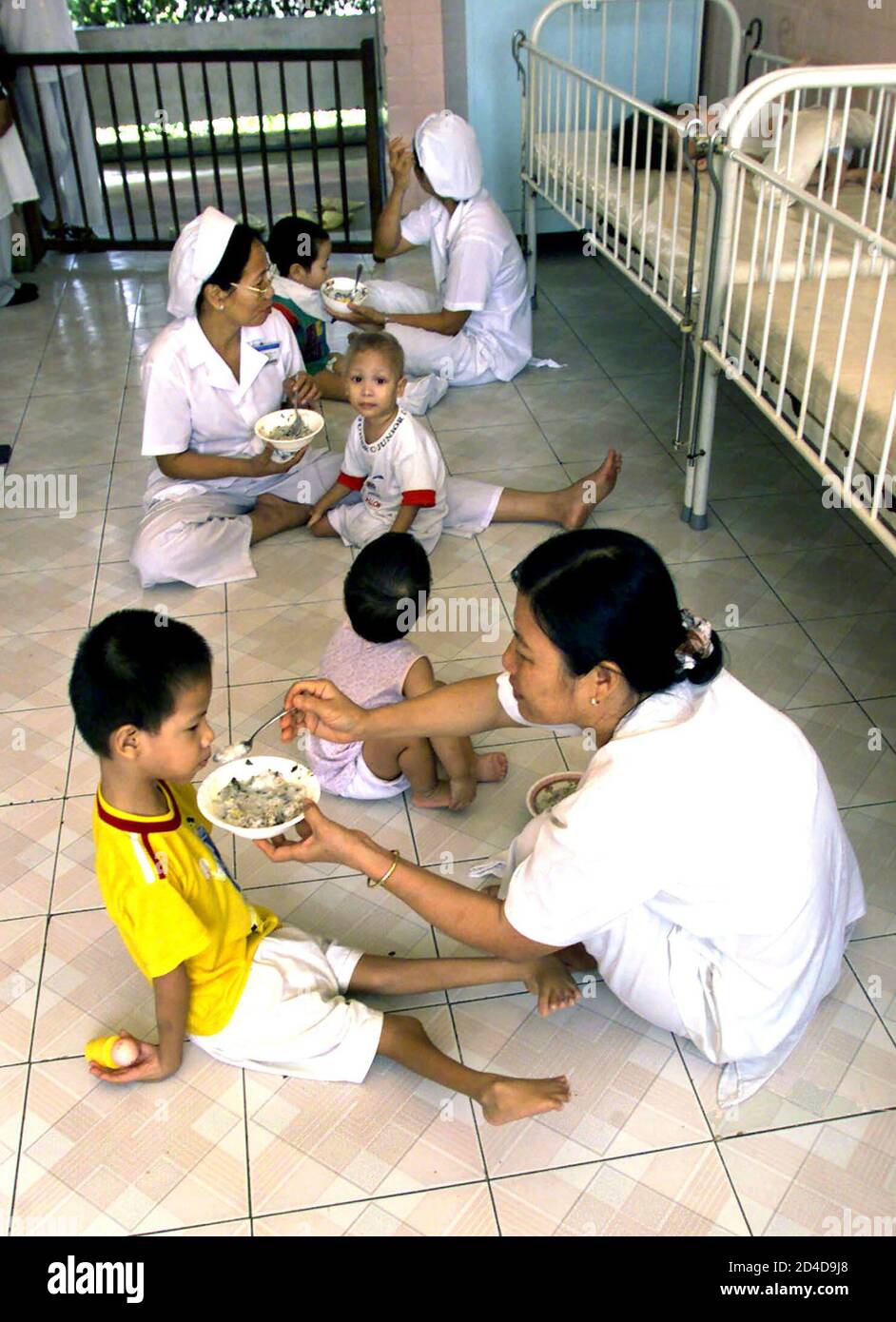 Nurses Feed Children With Birth Defects As A Result Of Their Parents Exposure To The Defoliant Agent Orange In A Special Wing Reserved For The Children At The Tu Du Women S Hospital Nurses Feed Children With Birth Defects As A Result Of Their Parents Exposure To The Defoliant Agent Orange In A Special Wing Reserved For The Children At The Tu Du Women S Hospital