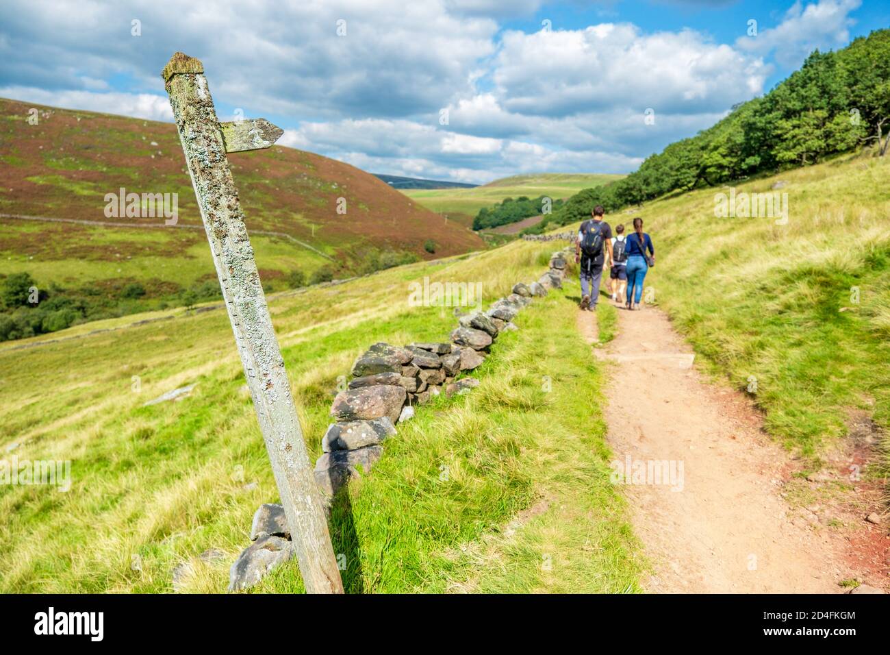 Marcheurs sur la voie de la chaussée vers le pont de trois Shires Parc national du Peak District Banque D'Images