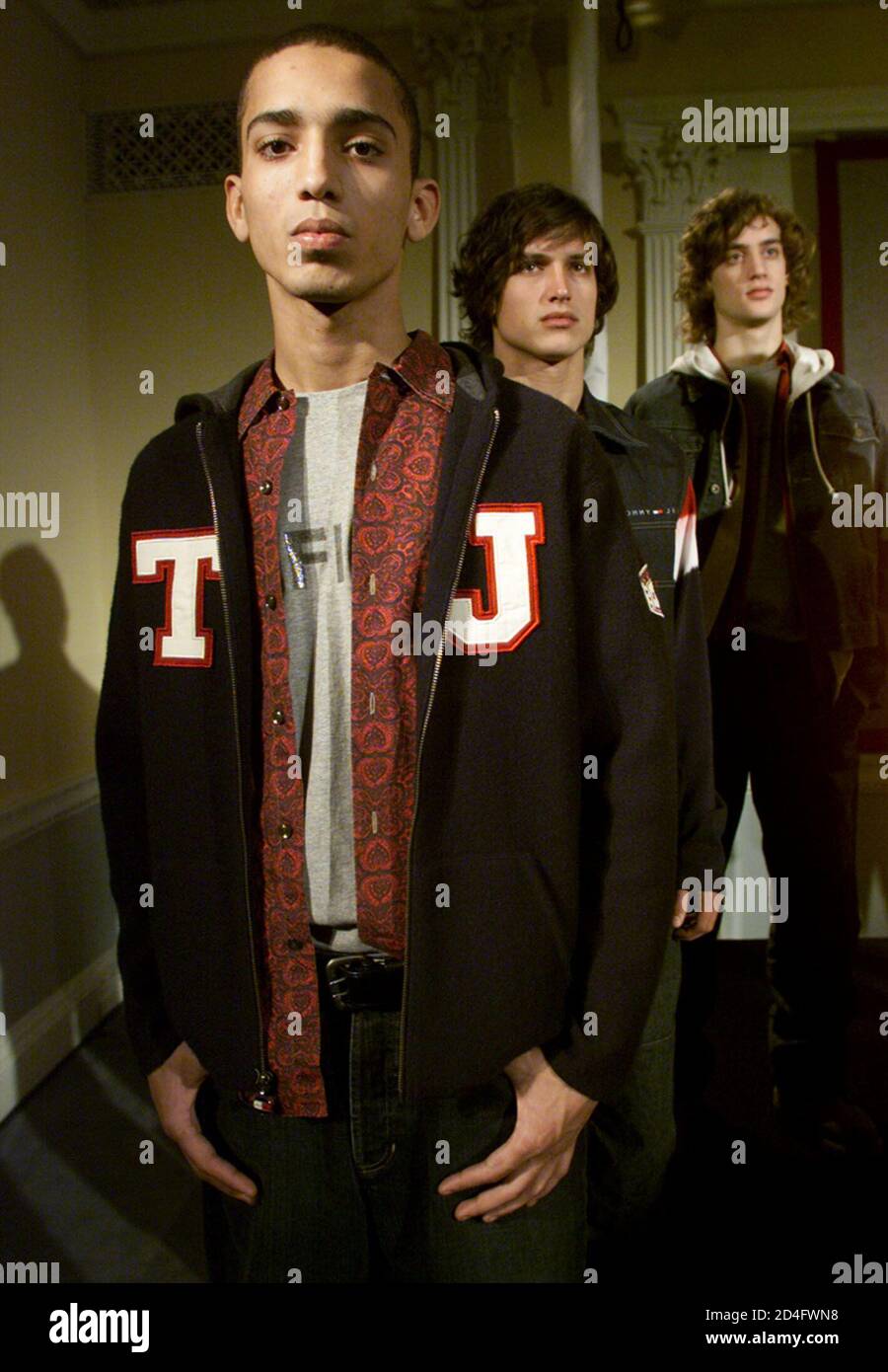 Designer Tommy Hilfiger's Men's Fall 2001 presentation, shown in New York  on February 8, 2001, "celebrates his long 'love story' with collegiate prep  and Ivy League style." Model Makoto (R) wears a