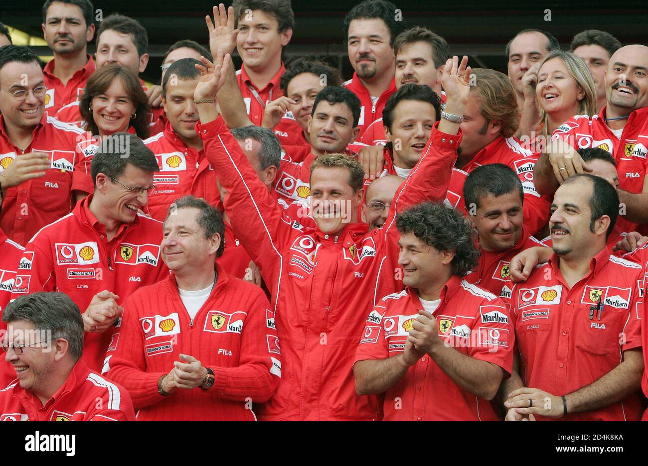 Ferrari driver Michael Schumacher (C) from Germany poses with mechanics  after the Belgian Formula One Grand Prix at the Spa-Francorchamps race  circuit August 29, 2004. Schumacher claimed a seventh world championship  despite