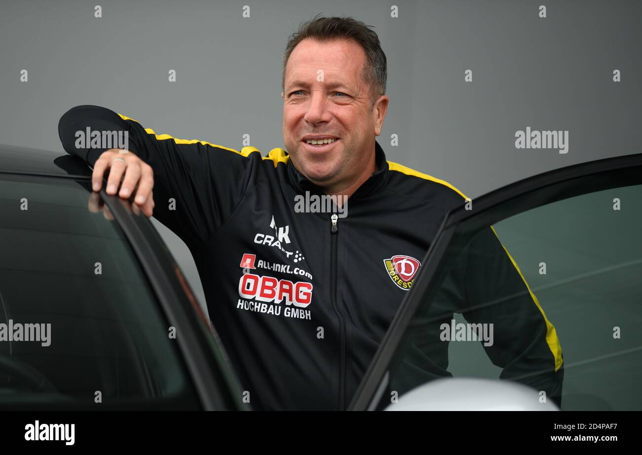 Dresde, Allemagne. 09e octobre 2020. Football: 3ème ligue, conférence de presse pour le 4ème jour d'allumette avant le SG Dynamo Dresden - 1er match du FC Magdeburg au transparent VW Manufactory. L'entraîneur de dynamos Markus Kauczinski est debout à un VW ID.3 pendant un rendez-vous de P.R. Credit: Robert Michael/dpa-Zentralbild/dpa/Alay Live News Banque D'Images