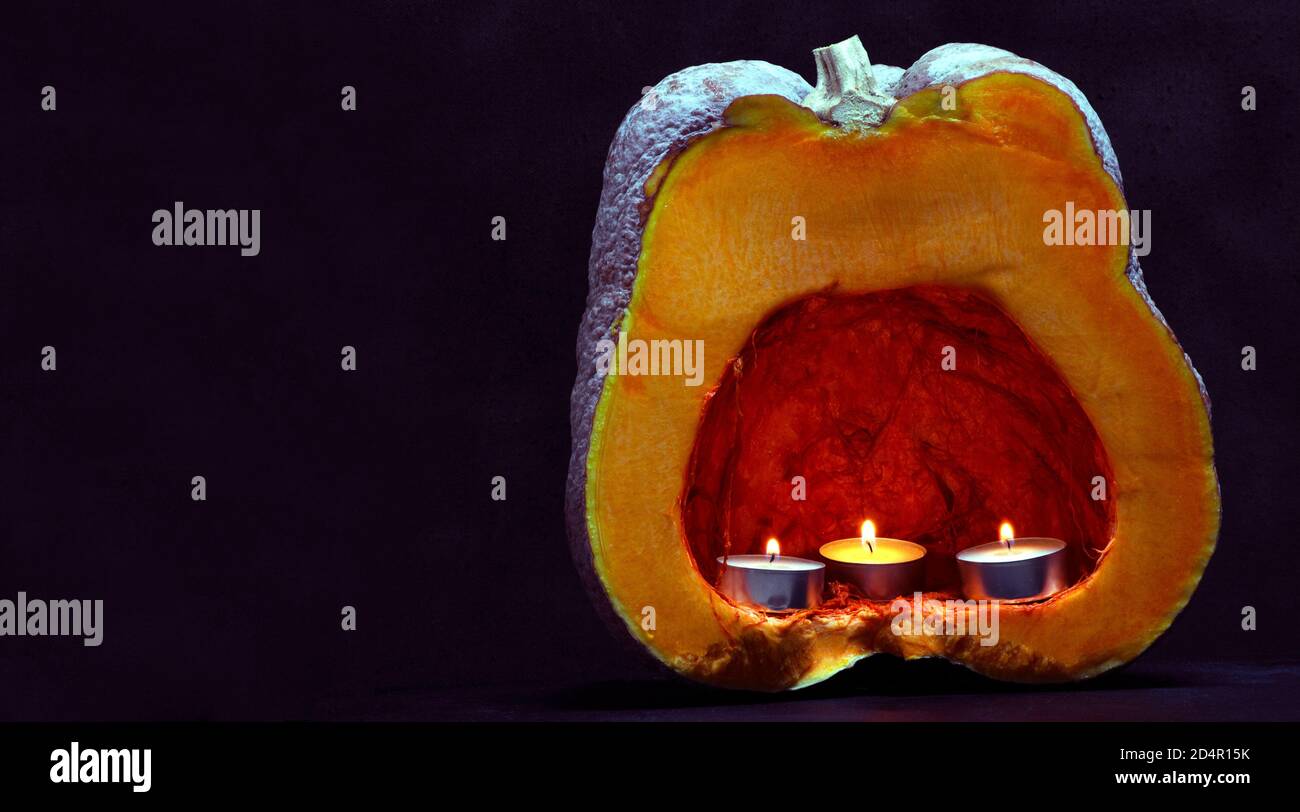 citrouille orange et trois bougies. concept pour la décoration d'halloween Banque D'Images