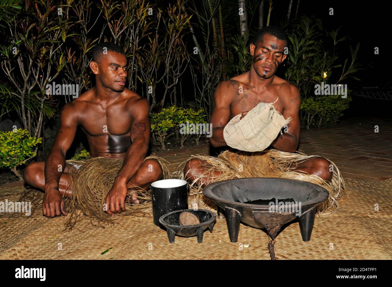 Deux Fidjiens s'écraseront dans un spectacle touristique pour servir la boisson nationale des Fidji, Yaqona, également appelée Kava aux Fidji dans le Pacifique Sud. Yaqona ou Kava Banque D'Images