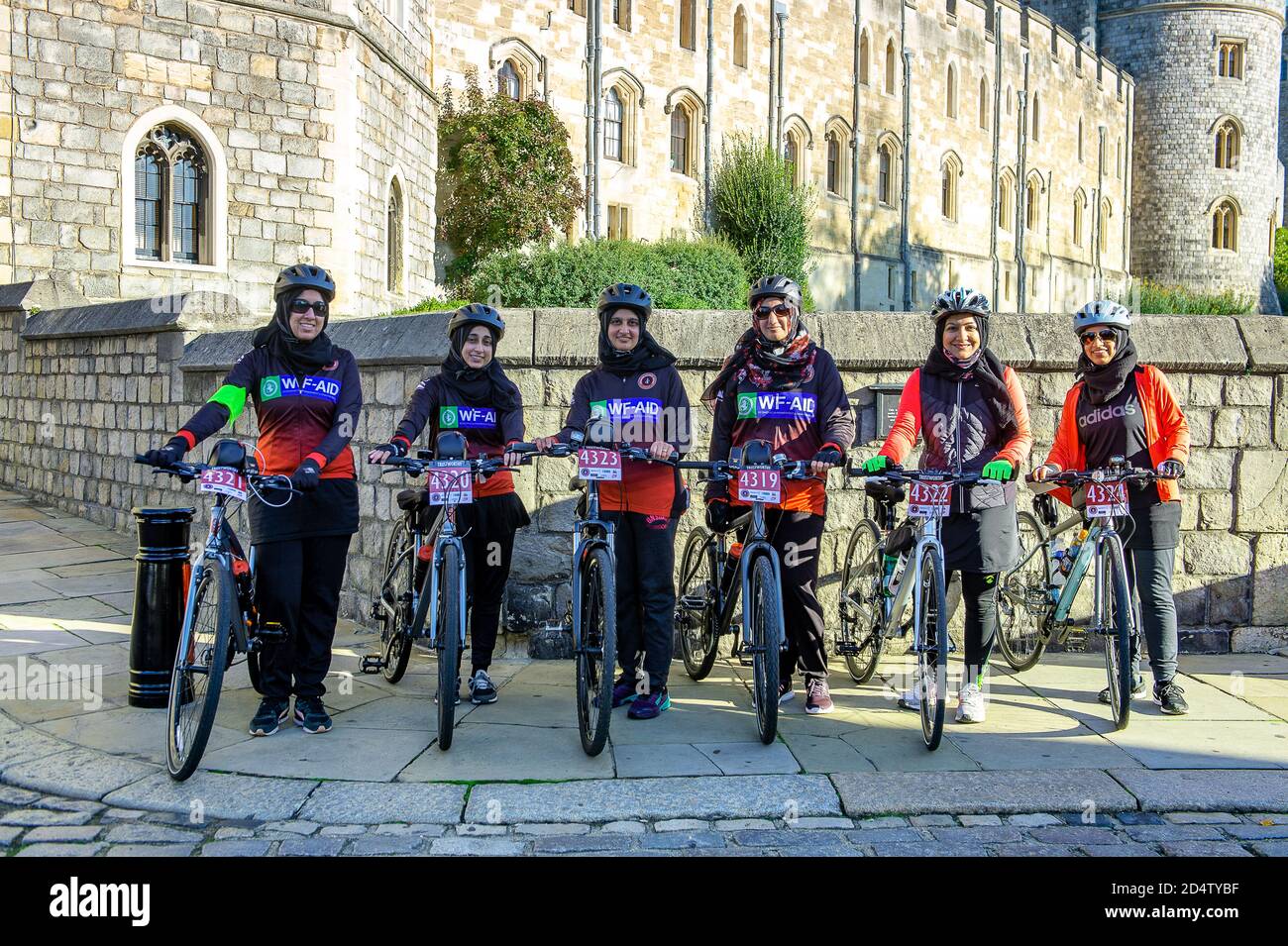 Windsor, Berkshire, Royaume-Uni. 11 octobre 2020. Ce matin, une fille pose pour une photo devant le château de Windsor alors qu'elle participe à une promenade en vélo parrainée par un organisme de bienfaisance de Stanmore à Windsor, en recueillant des fonds pour l'organisme international de bienfaisance WF-Aid. Vingt nouveaux cas de Covid-19 ont été signalés au cours des 24 dernières heures dans le quartier royal de Windsor et Maidenhead. Le gouvernement devrait annoncer un nouveau système de verrouillage à trois niveaux pour l'Angleterre après une deuxième pointe dans les cas positifs. Crédit : Maureen McLean/Alay Banque D'Images