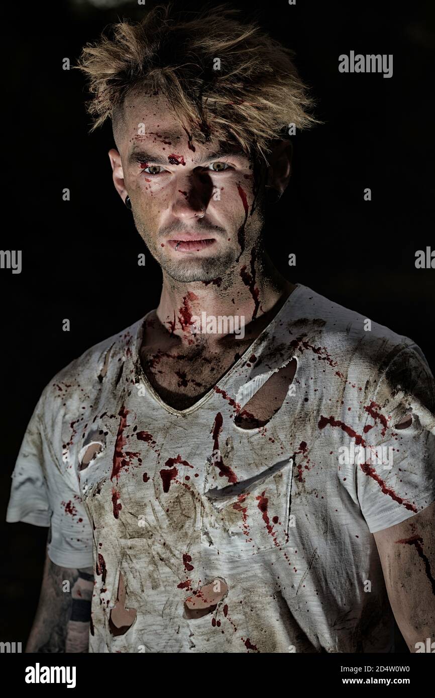 Jeune homme ghoulish recouvert de sang et portant une chemise déchirée  Photo Stock - Alamy