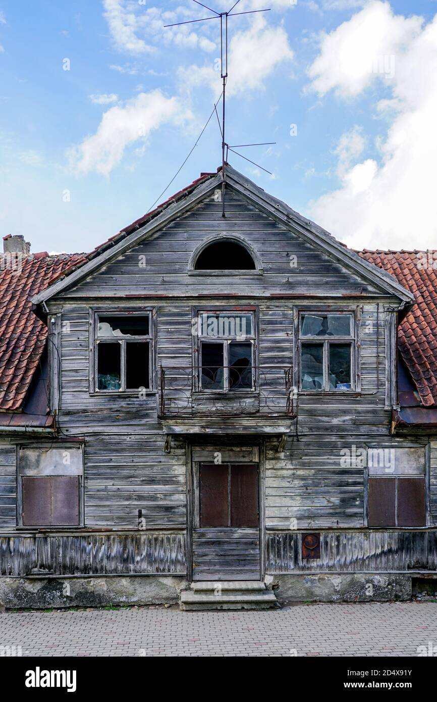 fragment de la façade d'une ancienne maison en bois avec un toit en argile sur fond bleu ciel Banque D'Images