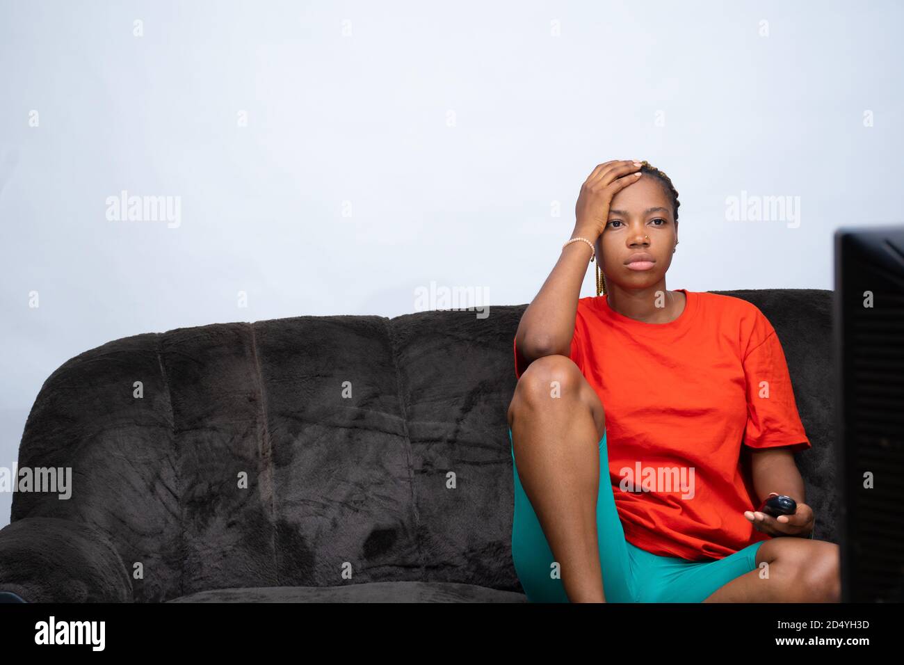 Femme africaine se sentant mécontent de ce qu'elle regarde à la télévision Banque D'Images