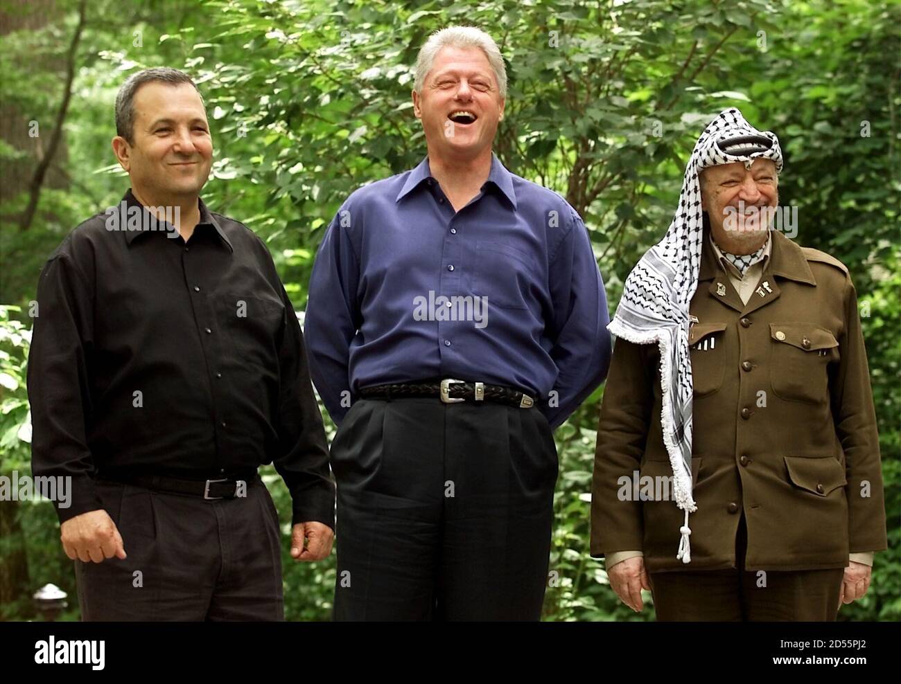 U.S. President Bill Clinton laughs as he refuses to answer questions with  Israeli Prime Minister Ehud Barak (L) and Palestinian President Yasser  Arafat (R) at Camp David during peace talks, July 11.