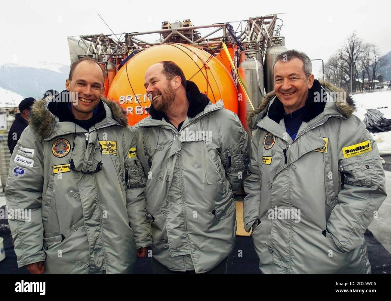 Le pilote de ballon Bertrand Piccard (L) de Suisse, Alan Noble (C) de la  Grande-Bretagne et le co-pilote Brian Jones de la Grande-Bretagne posent  pour les photographes devant la gondole du ballon