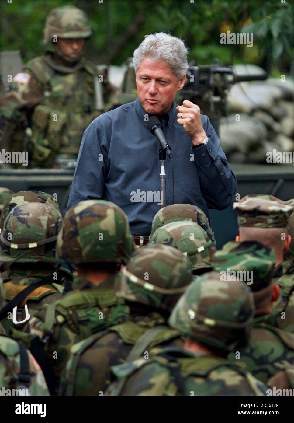 U.S. President Bill Clinton shakes a fist as he addresses United States  Army and Marine troops at Skopje Airport before departing at the close of  his six-hour trip to Macedonia June 22.