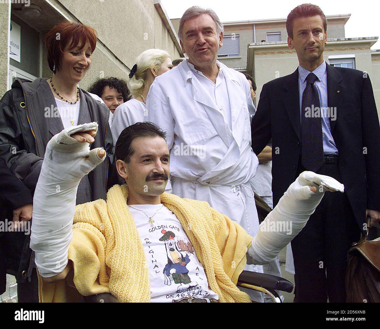 Denis Chatelier,33, who underwent what is claimed to be the World's first  double hand and forearm transplant, leaves the Edouard Herriot hospital in  Lyon, February 7. French surgeon Professor Jean-Michel Dubernard, who