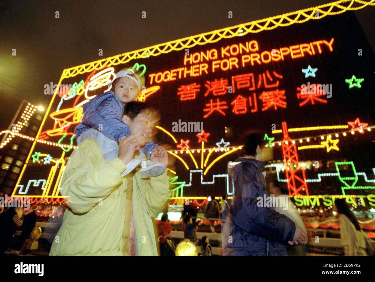 Hallmark Christmas Commercial 2022 Reindeer Revellers Walk Past Christmas Decorations Outside A Commercial Building At  Hong Kong's Tsim Sha Tsui Tourist District Late December 24. Colourful  Bulbs Forming Huge Pictures Of Santa, Reindeer, Angels Are A Christmas