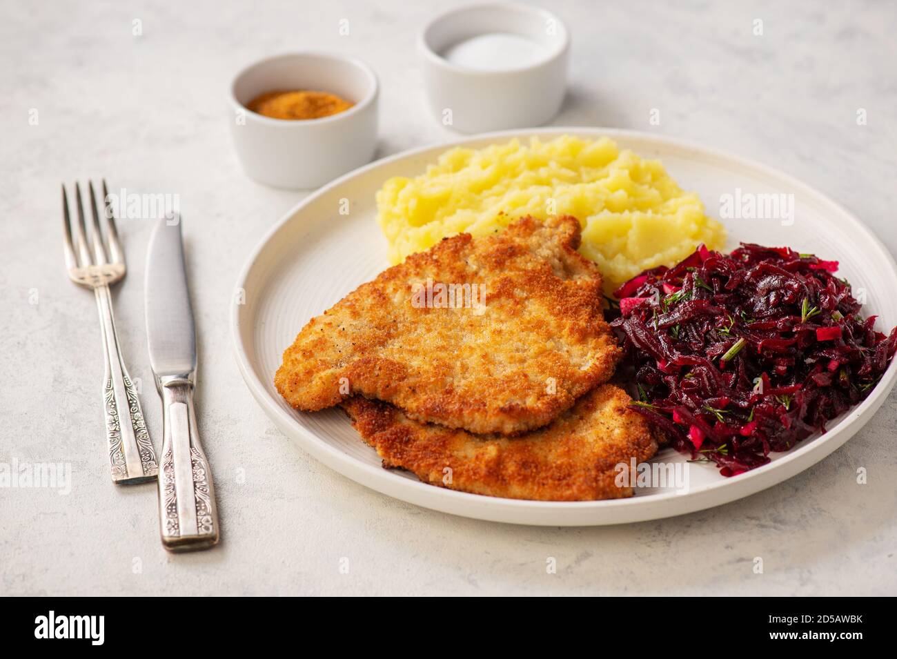 Hachez les côtelettes de porc, servies avec une purée de pommes de terre et une salade de betteraves. Banque D'Images