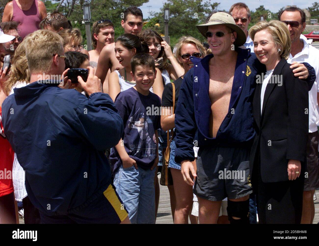 La première dame Hillary Rodham Clinton (R) pose pour une photo avec le  maître nageur A.J. Hepworth, le maître-nageur Chris Zang, photographie lors  de la visite de Clinton à Jones Beach, sur